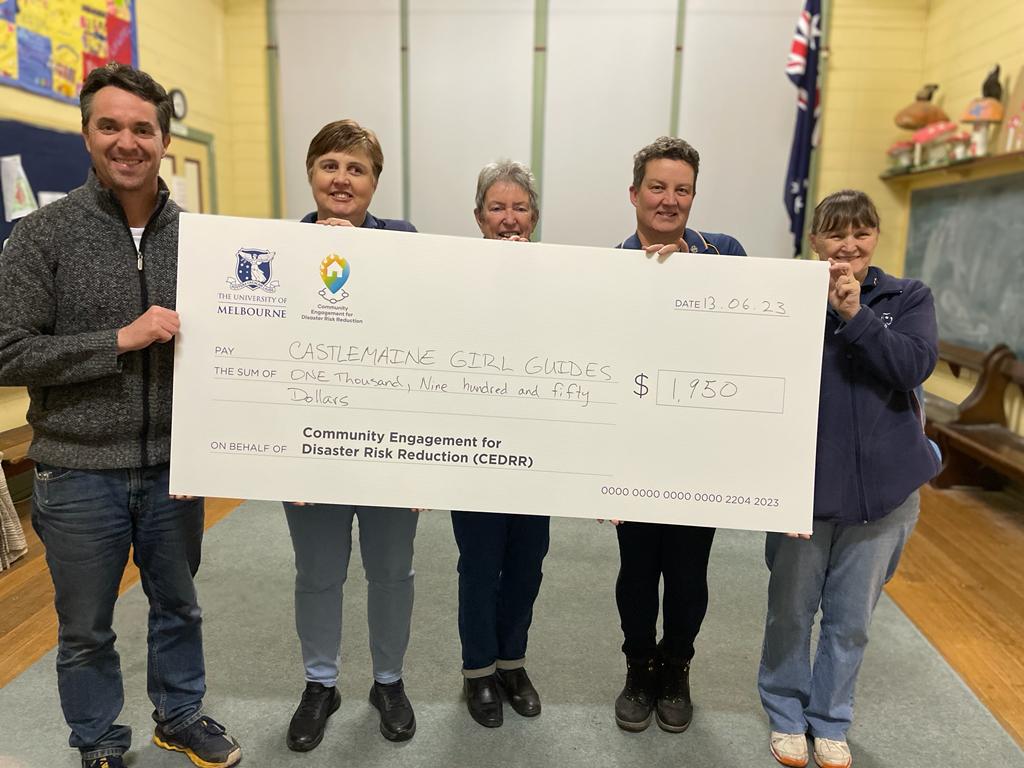 The presentation of the cheque from the University of Melbourne research team.